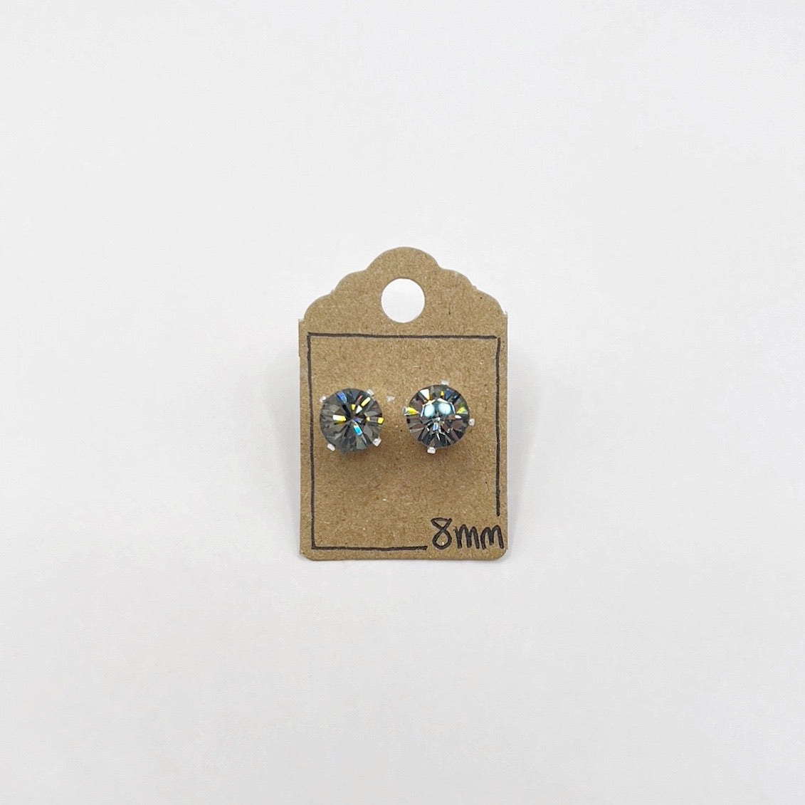Pair of cut glass stud earrings on a cardboard backing with '8mm' marking on a white background
