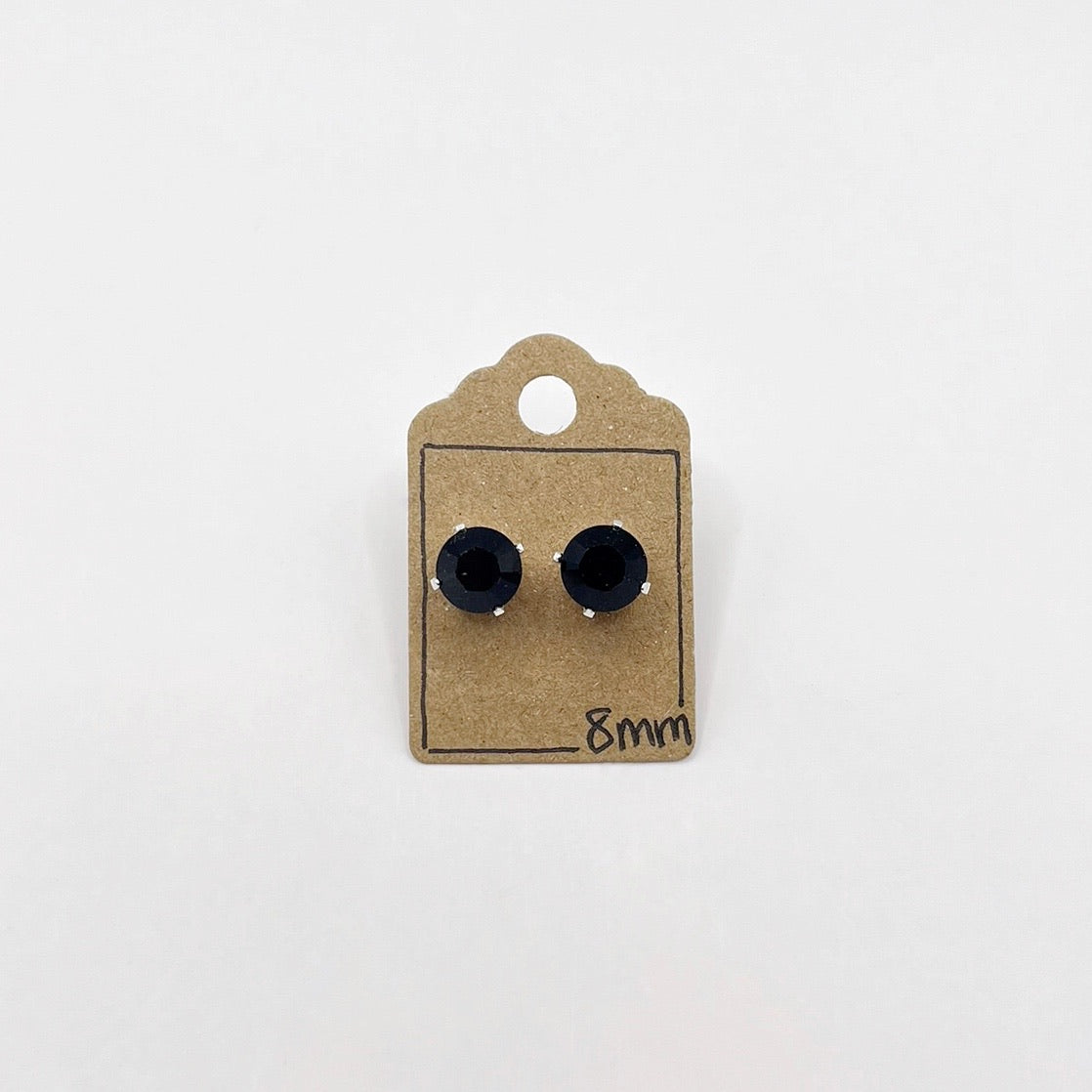 Black cut glass earrings on a cardboard backing with '8mm' text on a white background