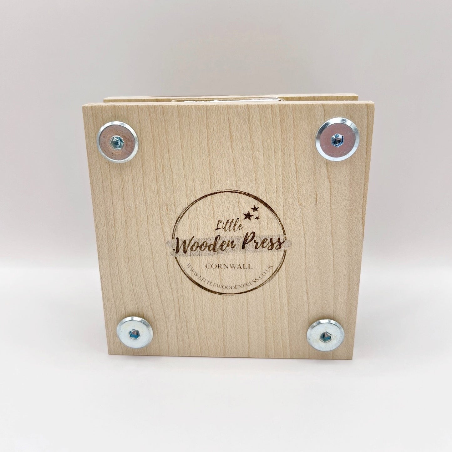 Back of the wooden flower press with 'Little Wooden Press' branding on a white background