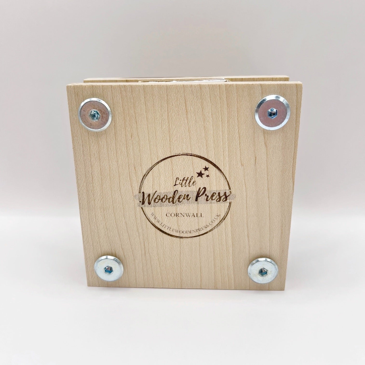 Back of the wooden flower press with 'Little Wooden Press' branding on a white background