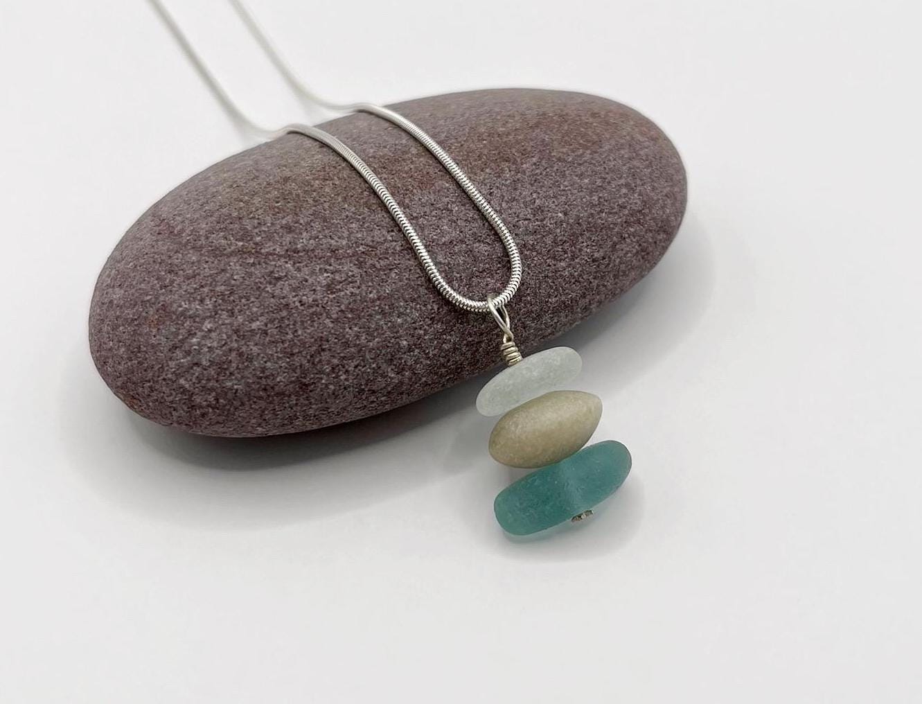 Necklace with beach glass pendants on a stone