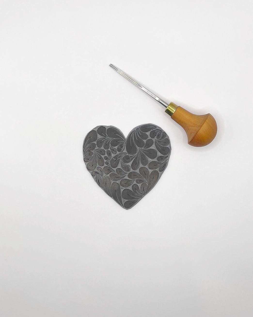 Lino and cutting tool used to make notebook on a white background