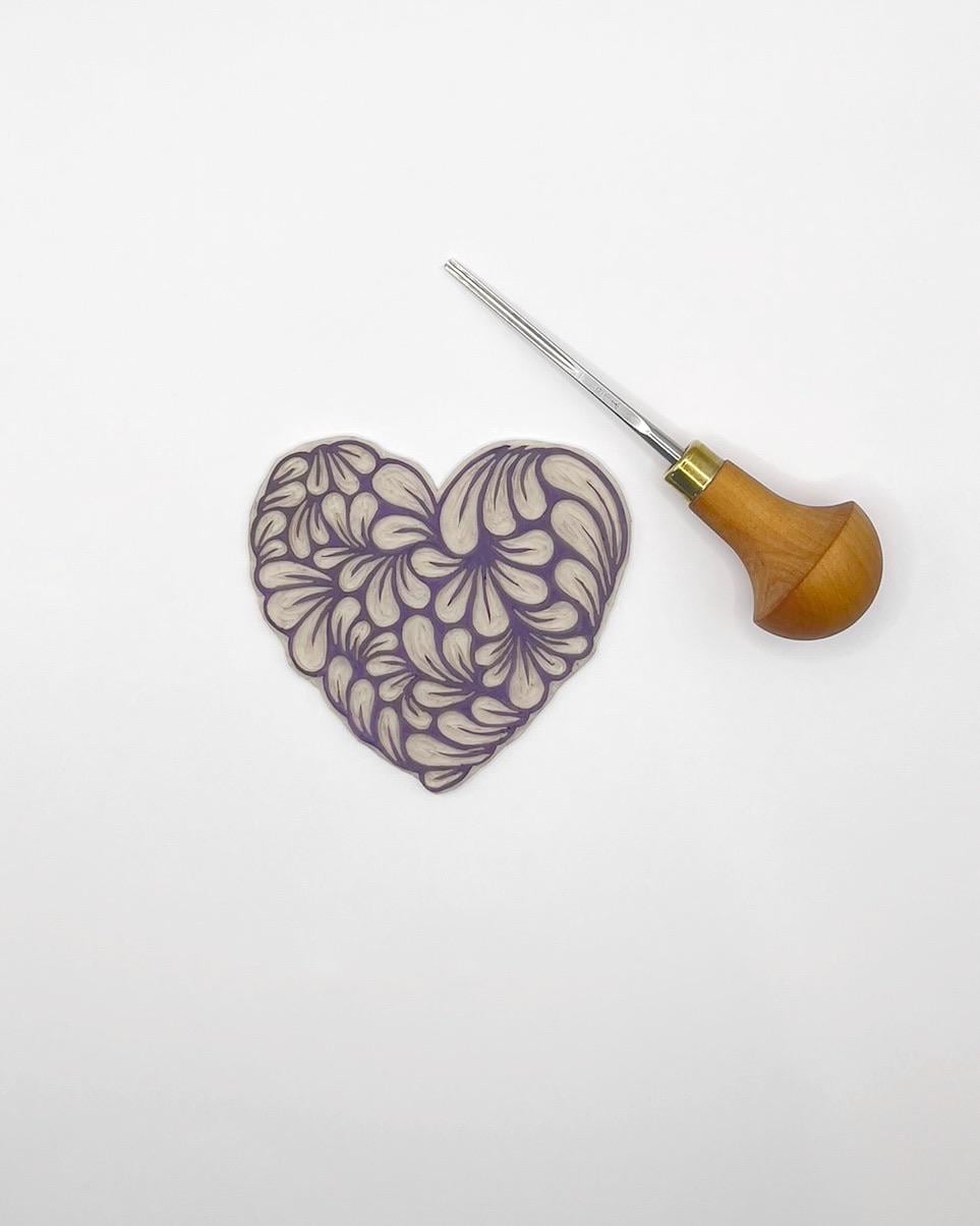 Lino and cutting tool used to create heart printed sketchbook