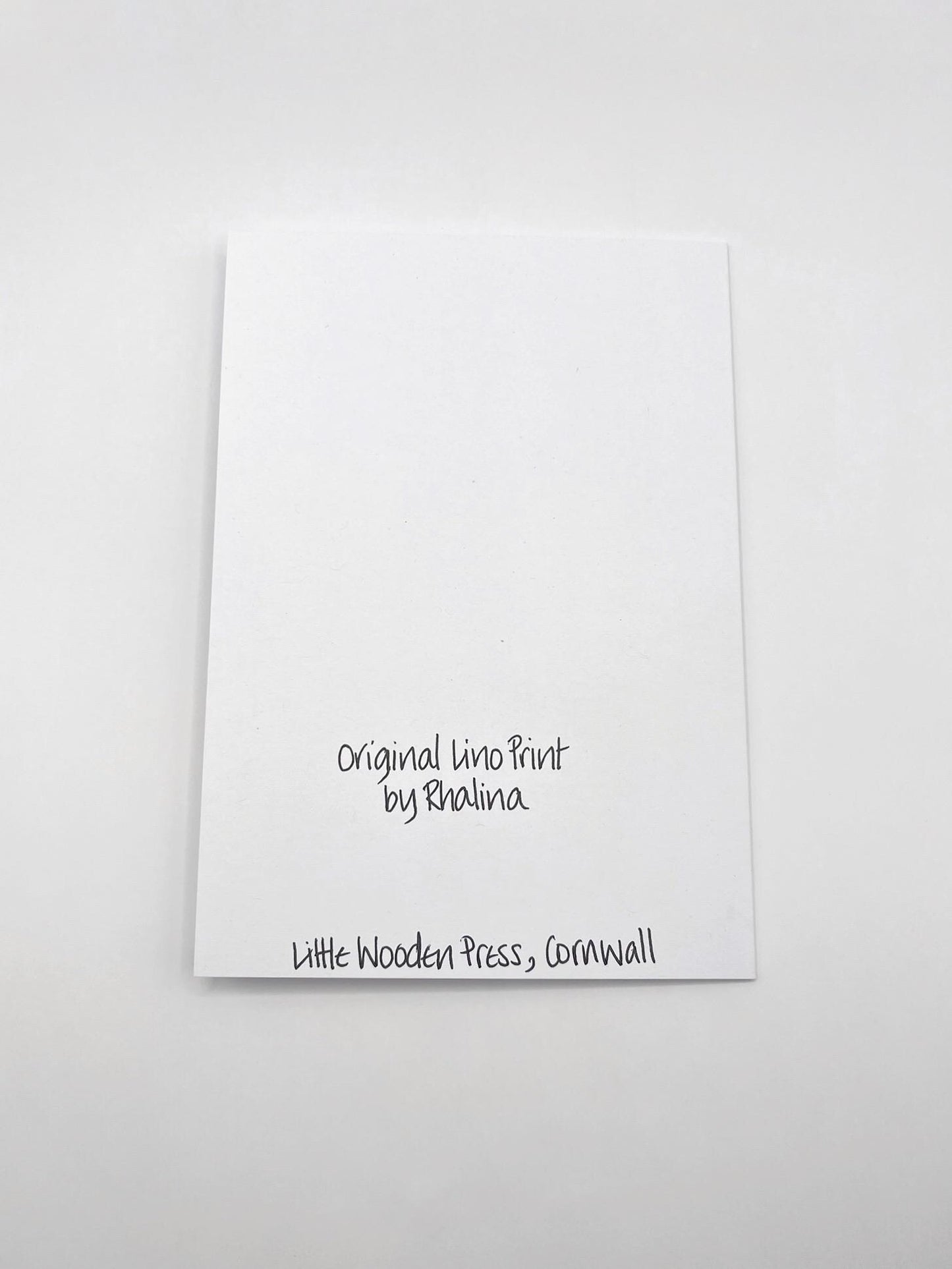 Showing the back of the seahorse card with black text laid on a white background.