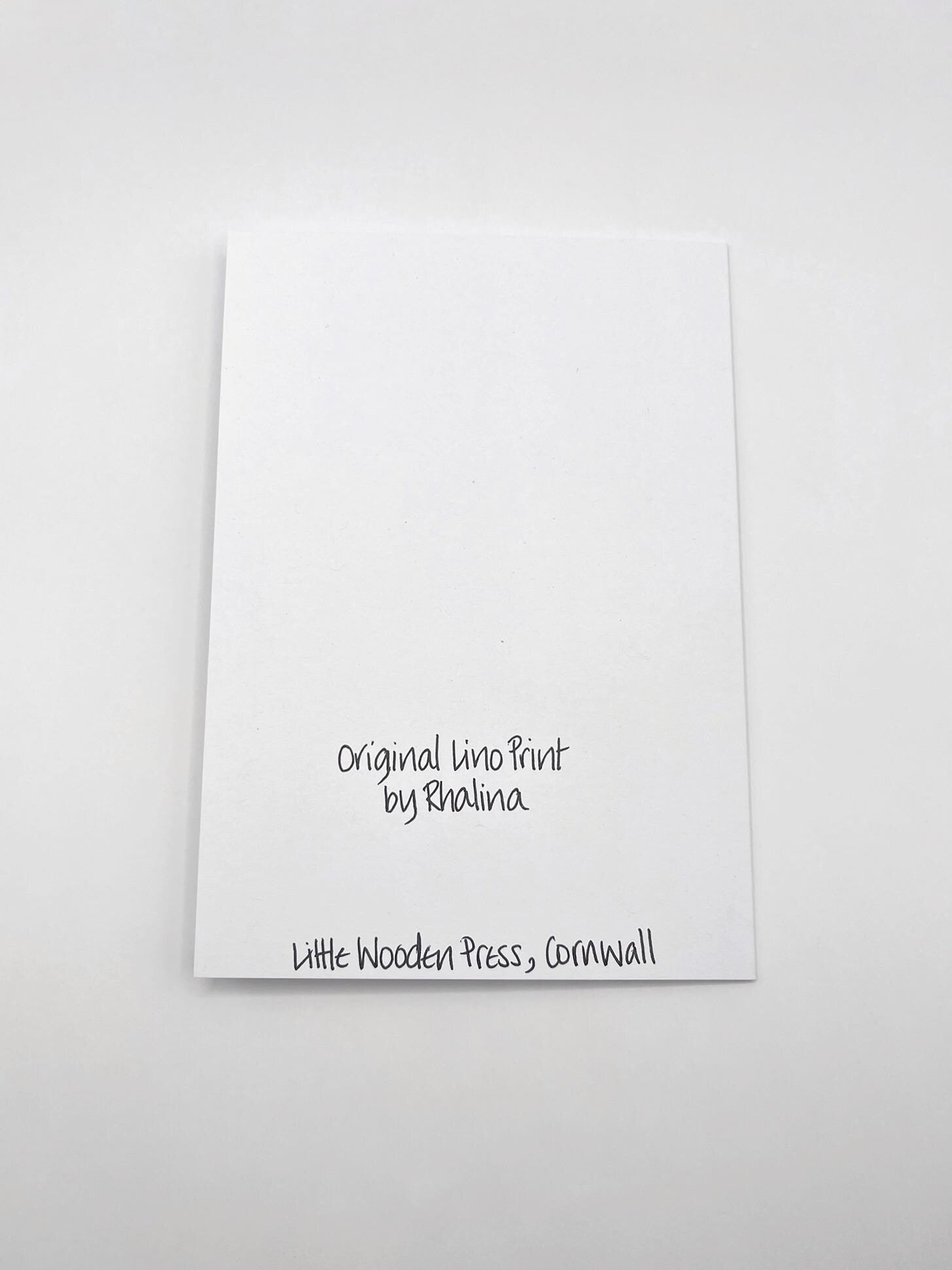 Showing the back of the seahorse card with black text laid on a white background.