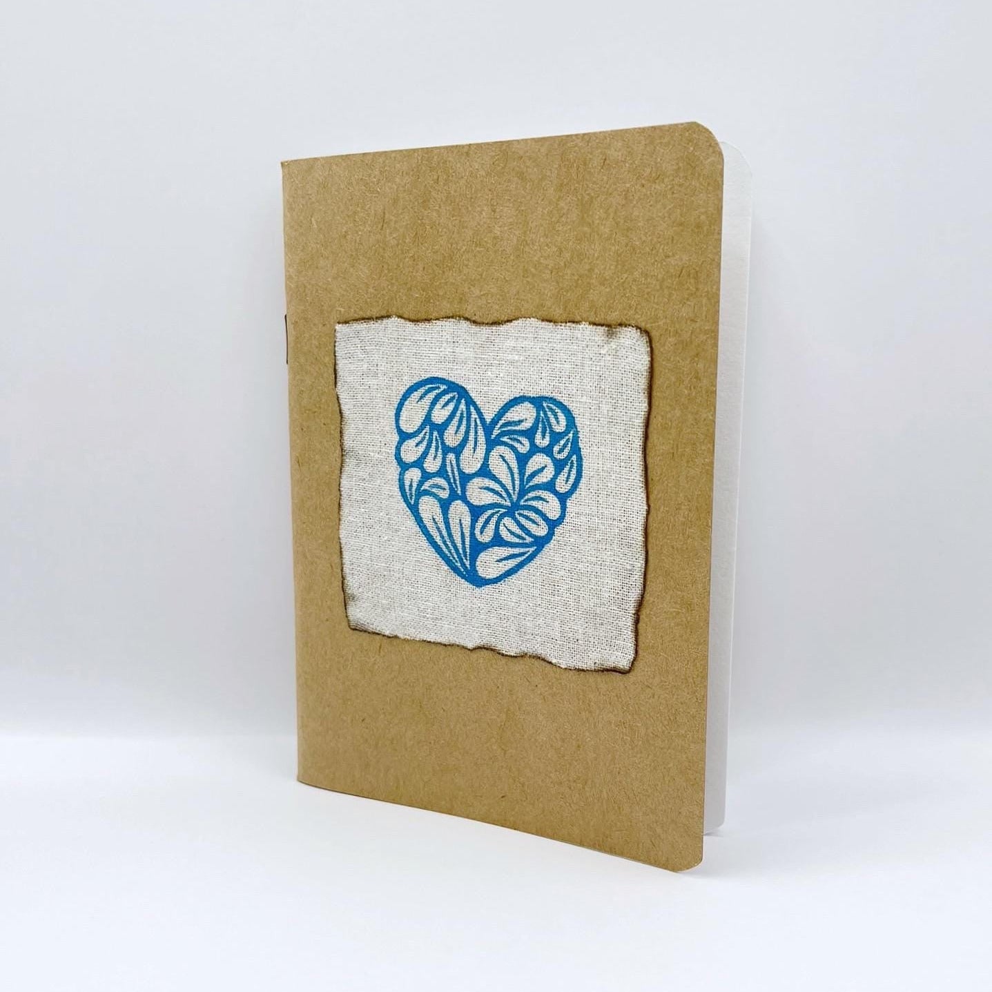 Notebook with a blue heart design on a white background