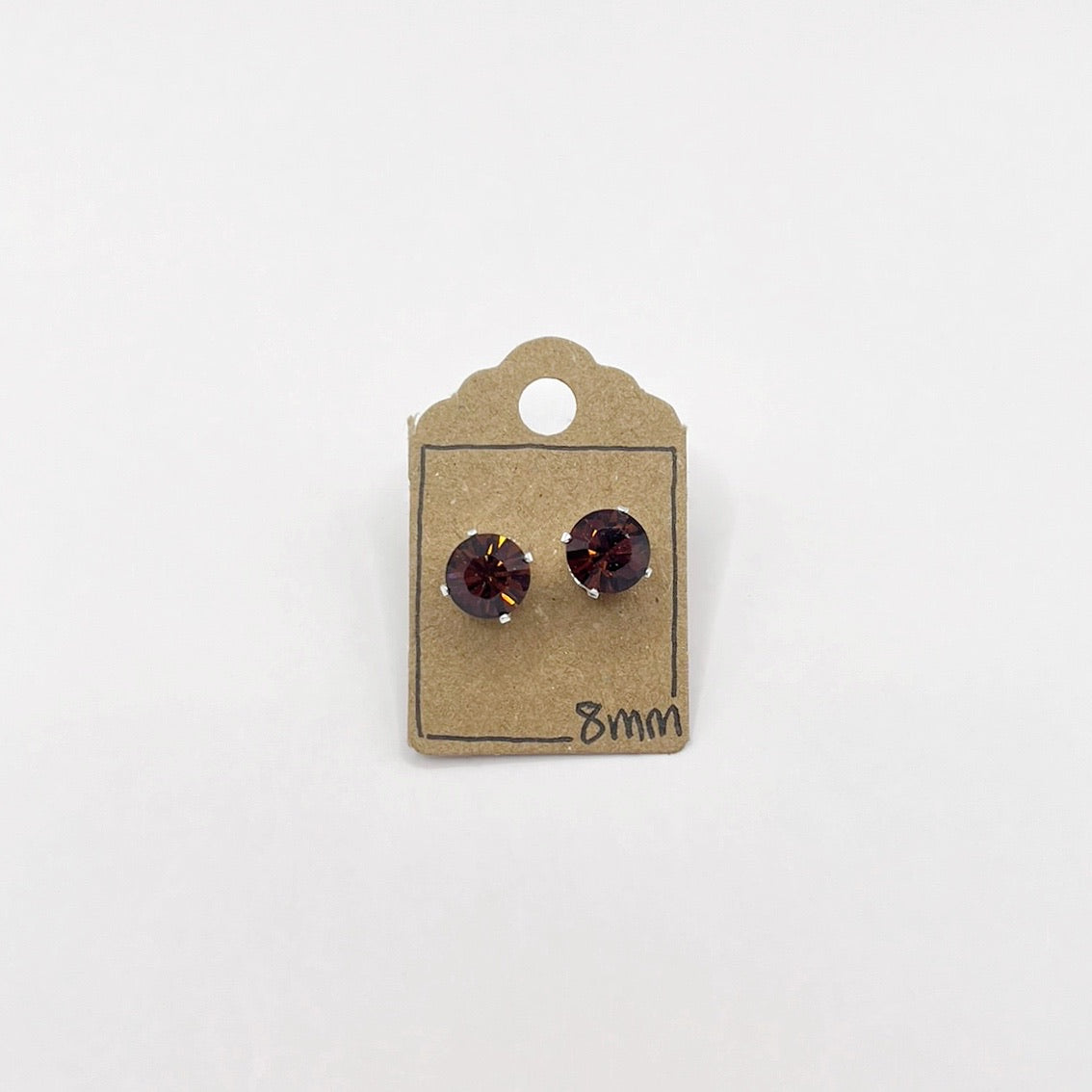 Pair of cut glass stud earrings on a cardboard backing labeled '8mm' against a white background.