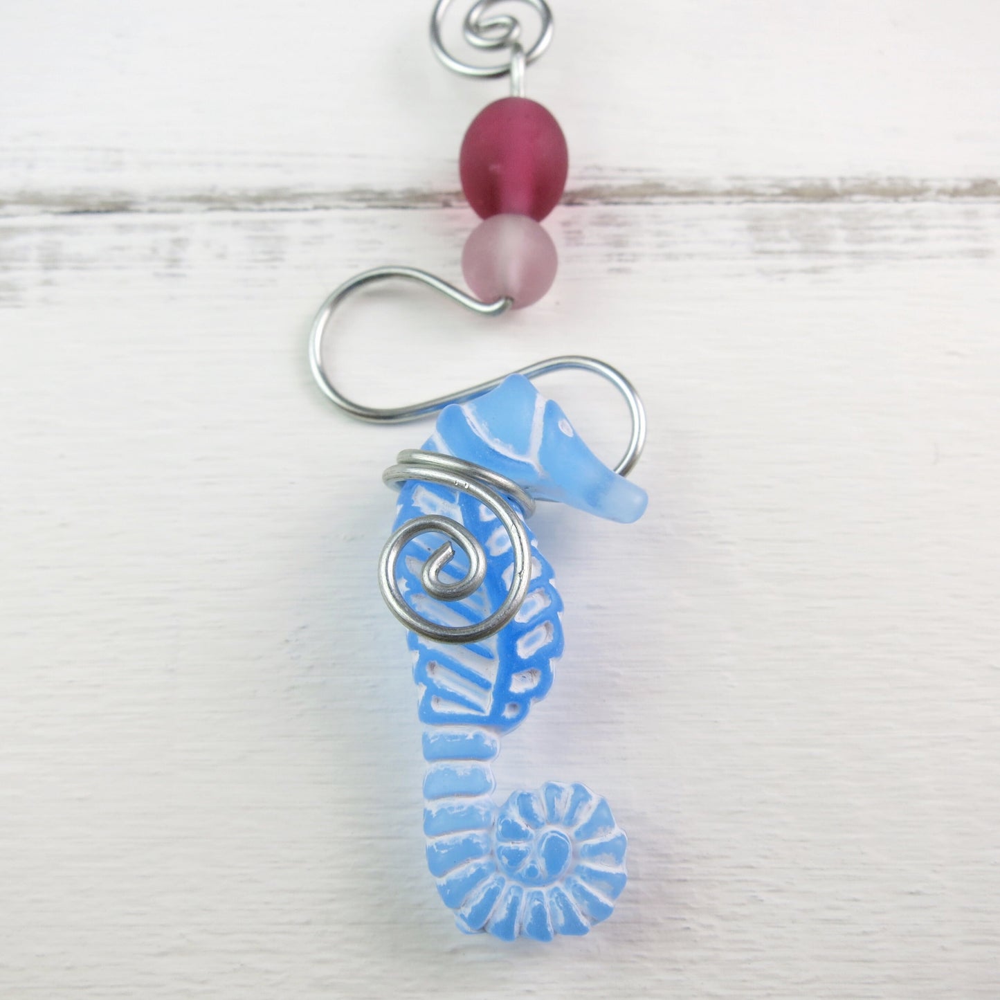 Close up of the seahorse on the driftwood mobile