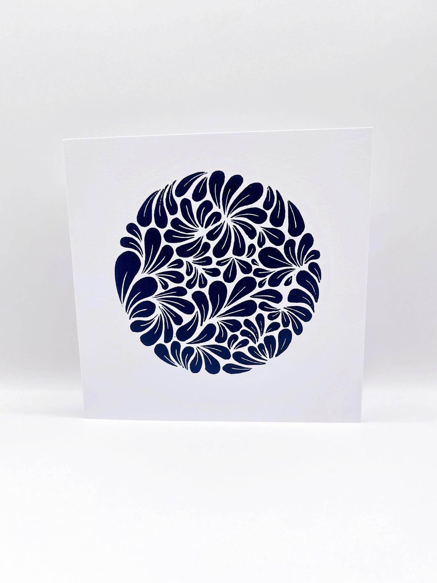 White card with an original navy blue lino print mussel shelll pattern on a white background