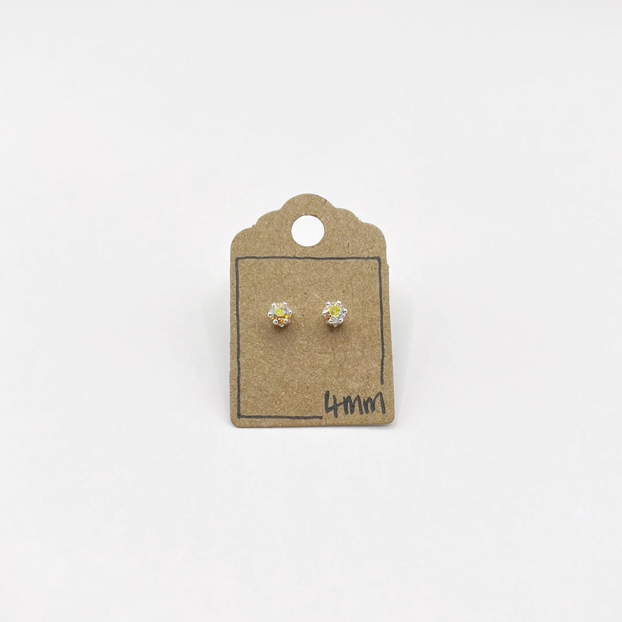 Pair of cut glass stud earrings on a small cardboard holder with '4mm' marking on a white background