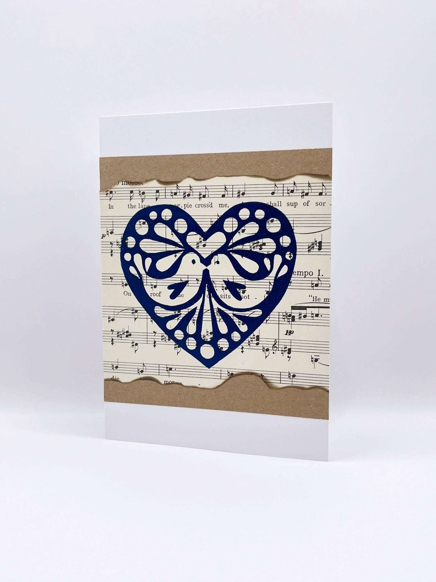 Greeting card with a blue heart design on a sheet music background