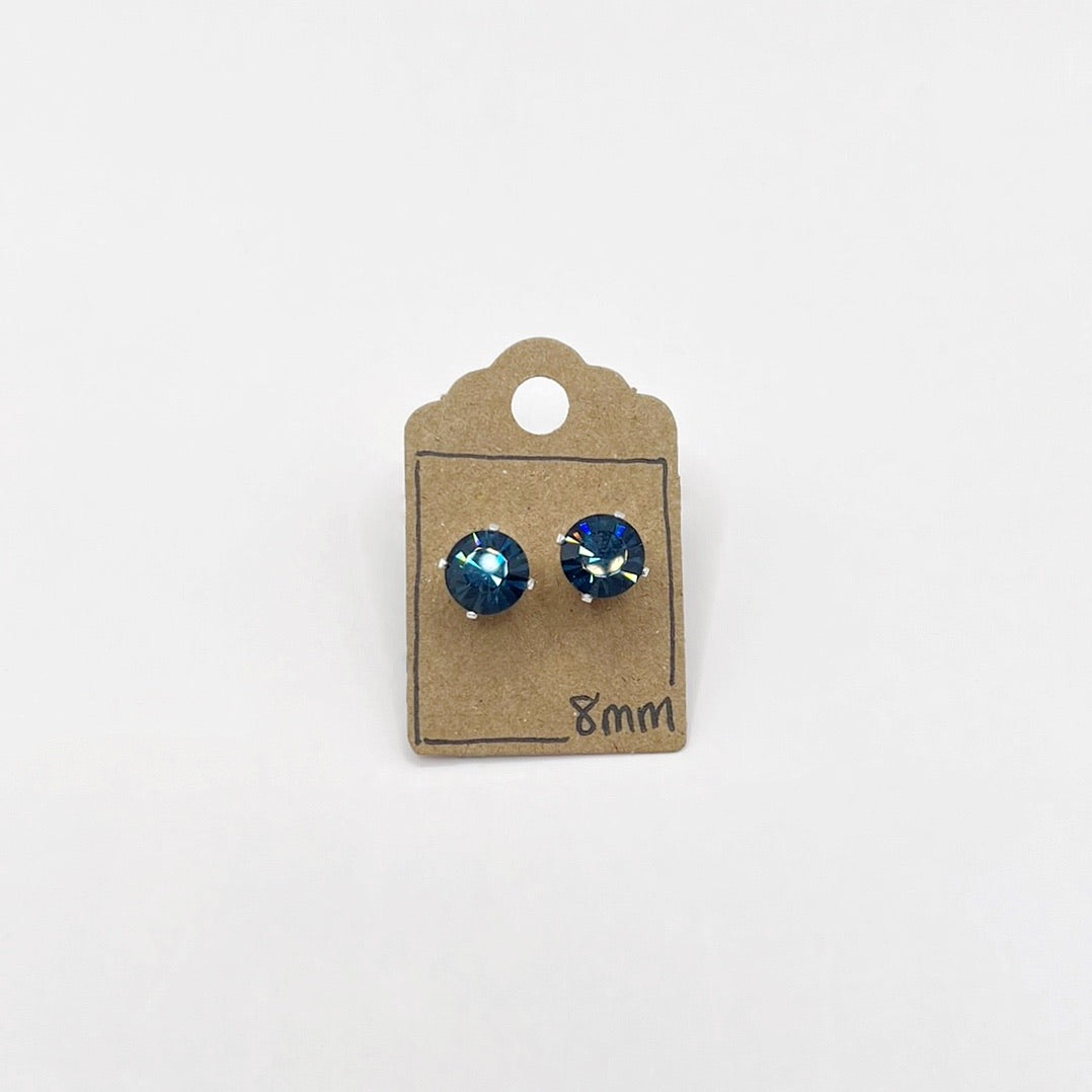 Pair of blue cut glass stud earrings on a cardboard backing with '8mm' text on a white background