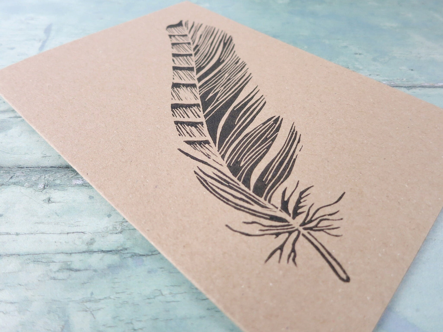 close up of original feather lino print on Kraft card
