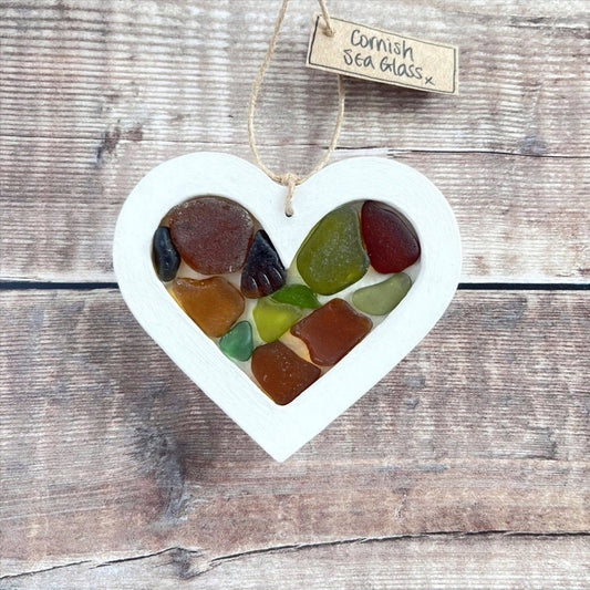 Heart-shaped sea glass hanging decoration with a 'Cornish Sea Glass' tag on a wooden surface