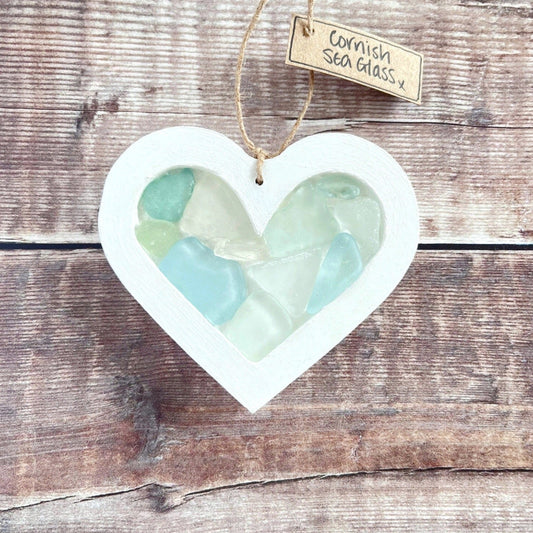 Heart-shaped sea glass hanging decoration with a 'Cornish Sea Glass' tag on a wooden surface