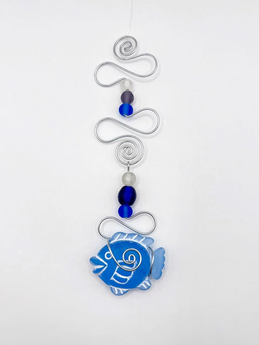 Decorative hanging ornament with blue fish design, wire and glass beads on a white background