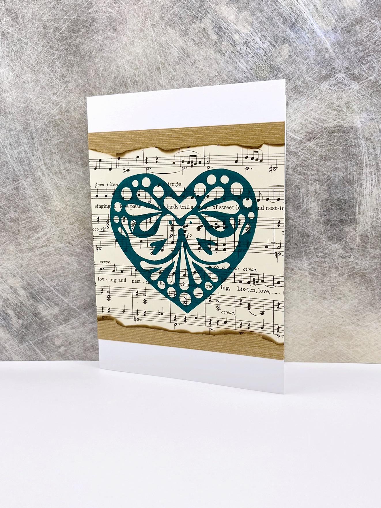 Card with decorative heart design on a sheet music background