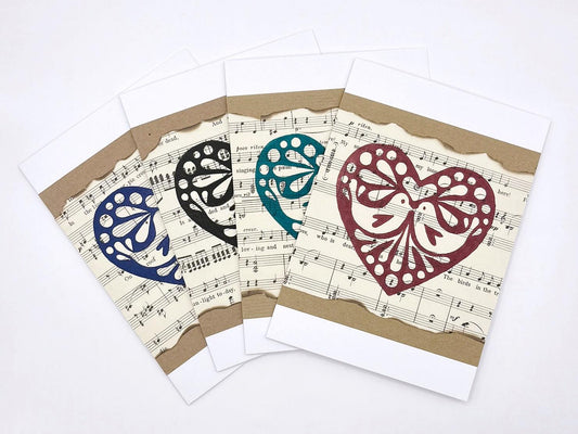Set of greeting cards with decorative hearts on a sheet music background
