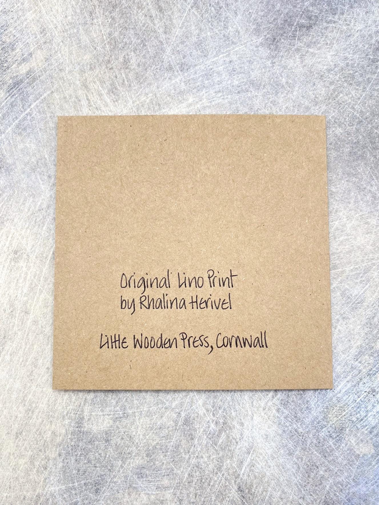 Showing the back of the Kraft card with text on a textured grey background